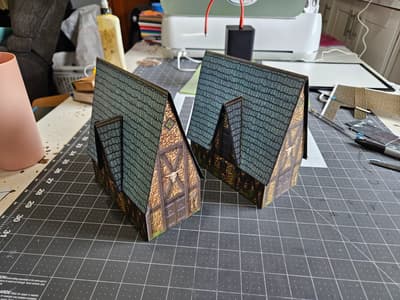 A folding version of a building and the rigid version behind it.